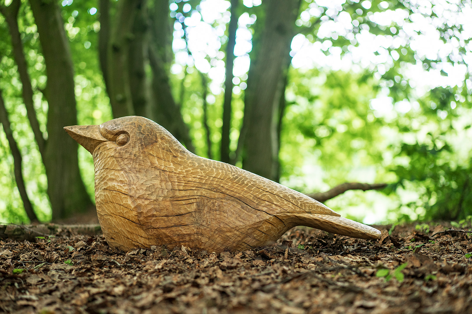 a close view of a wooden bird sculpture.