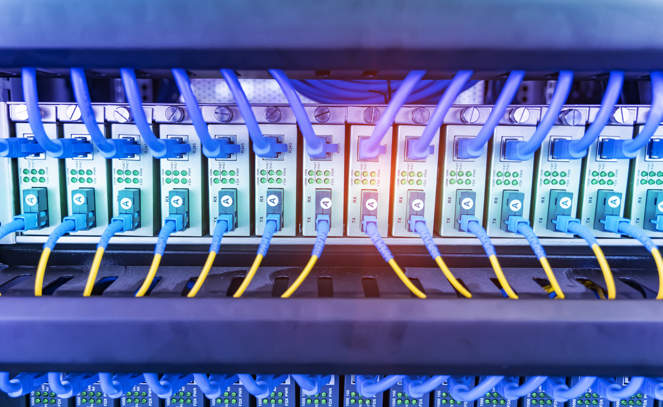 Fiber Optical cables connected to an optic ports and Network cables connected to ethernet ports